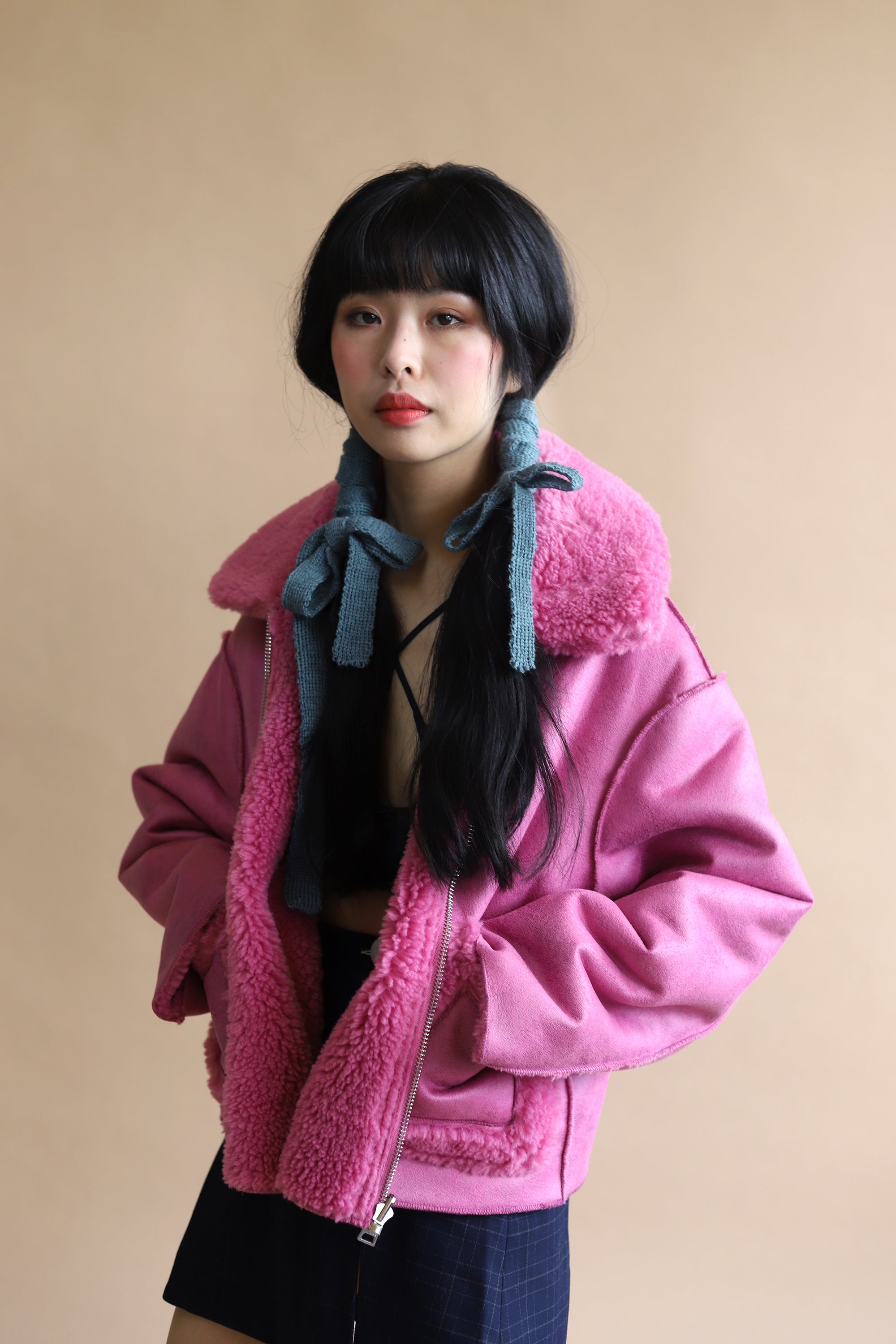 AW23 campaign shot of jakke shearling aviator in bubblegum pink