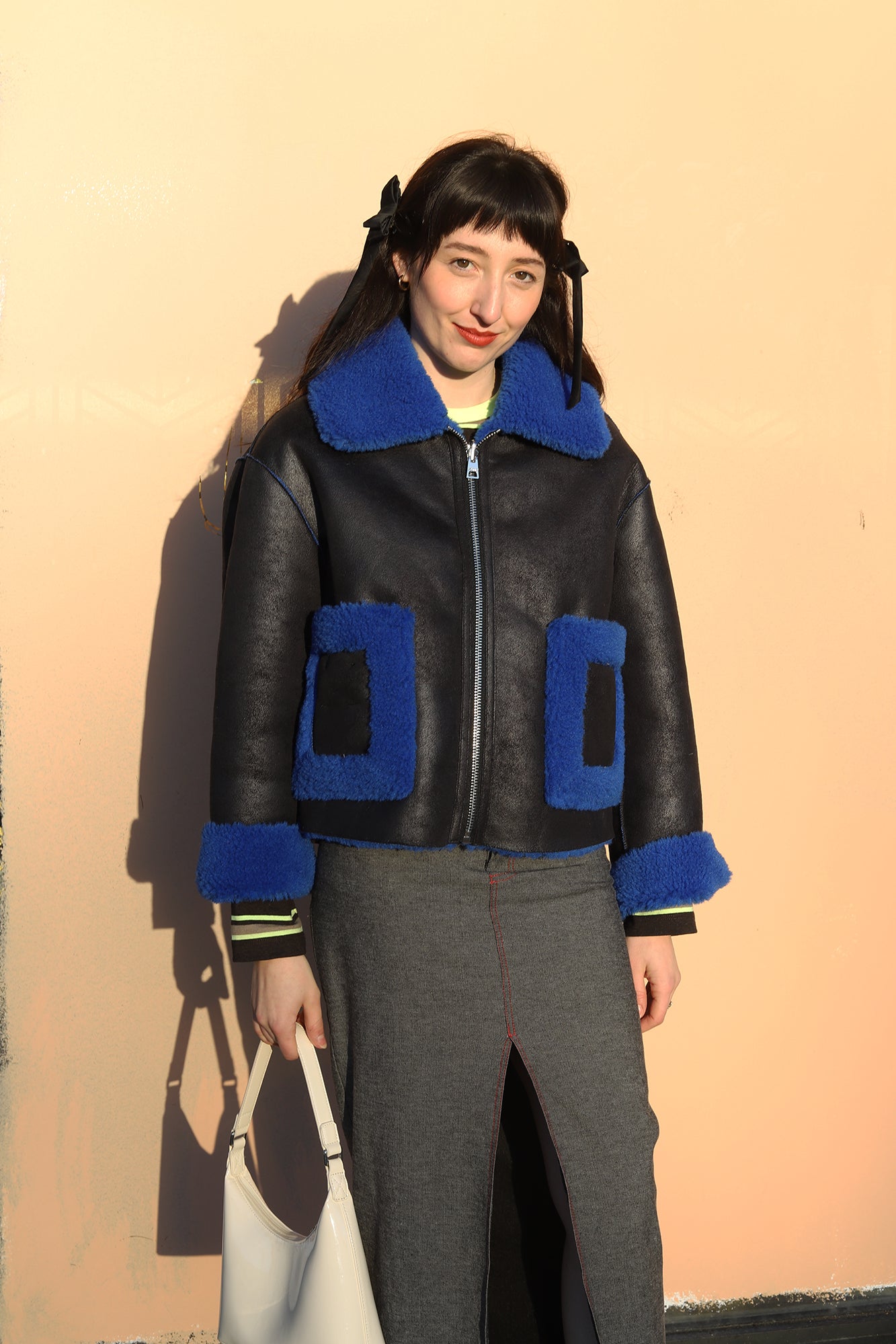 Elizabeth wearing jakke shearling aviator coat in lack and blue