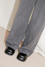 black to grey daruma trousers with miista coral shoes