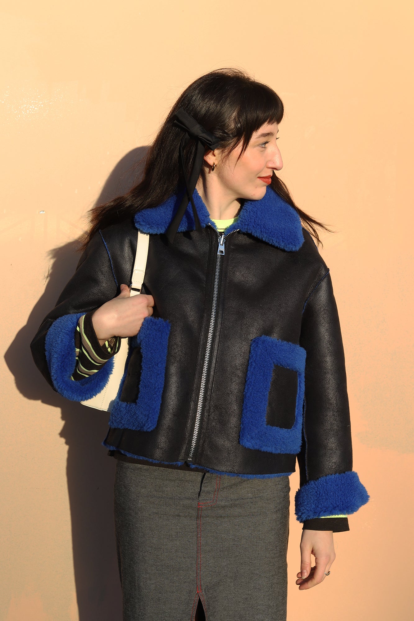 Elizabeth wearing jakke shearling aviator coat  in lack and blue
