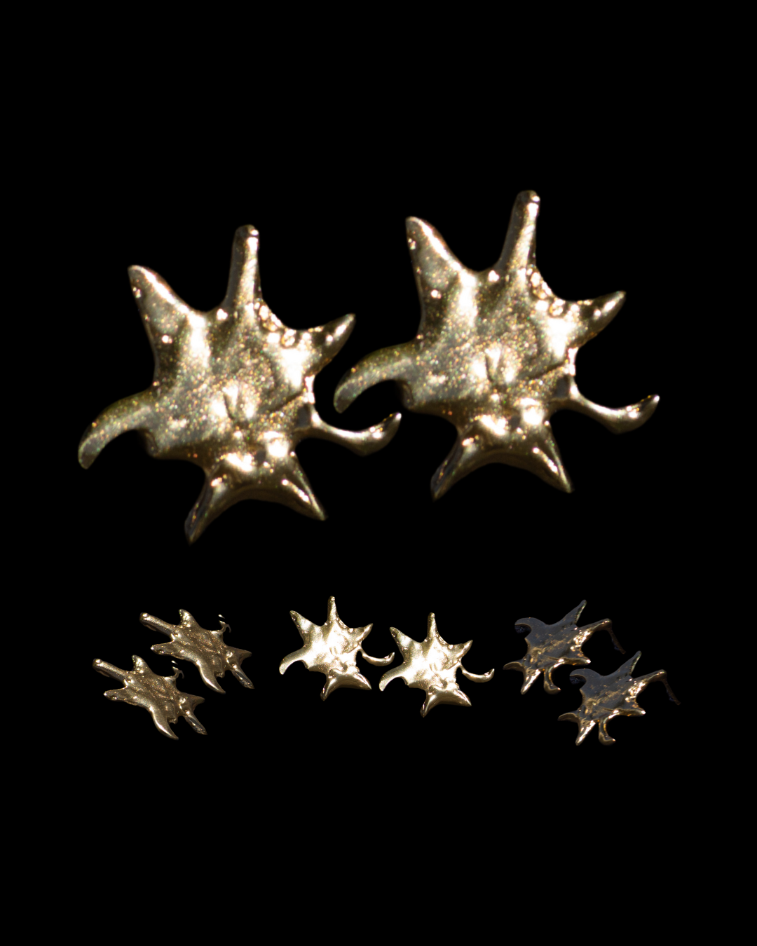 Star-shaped silver earrings on a black background