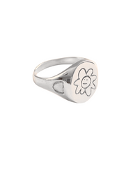 Silver ring with a floral design on a white background